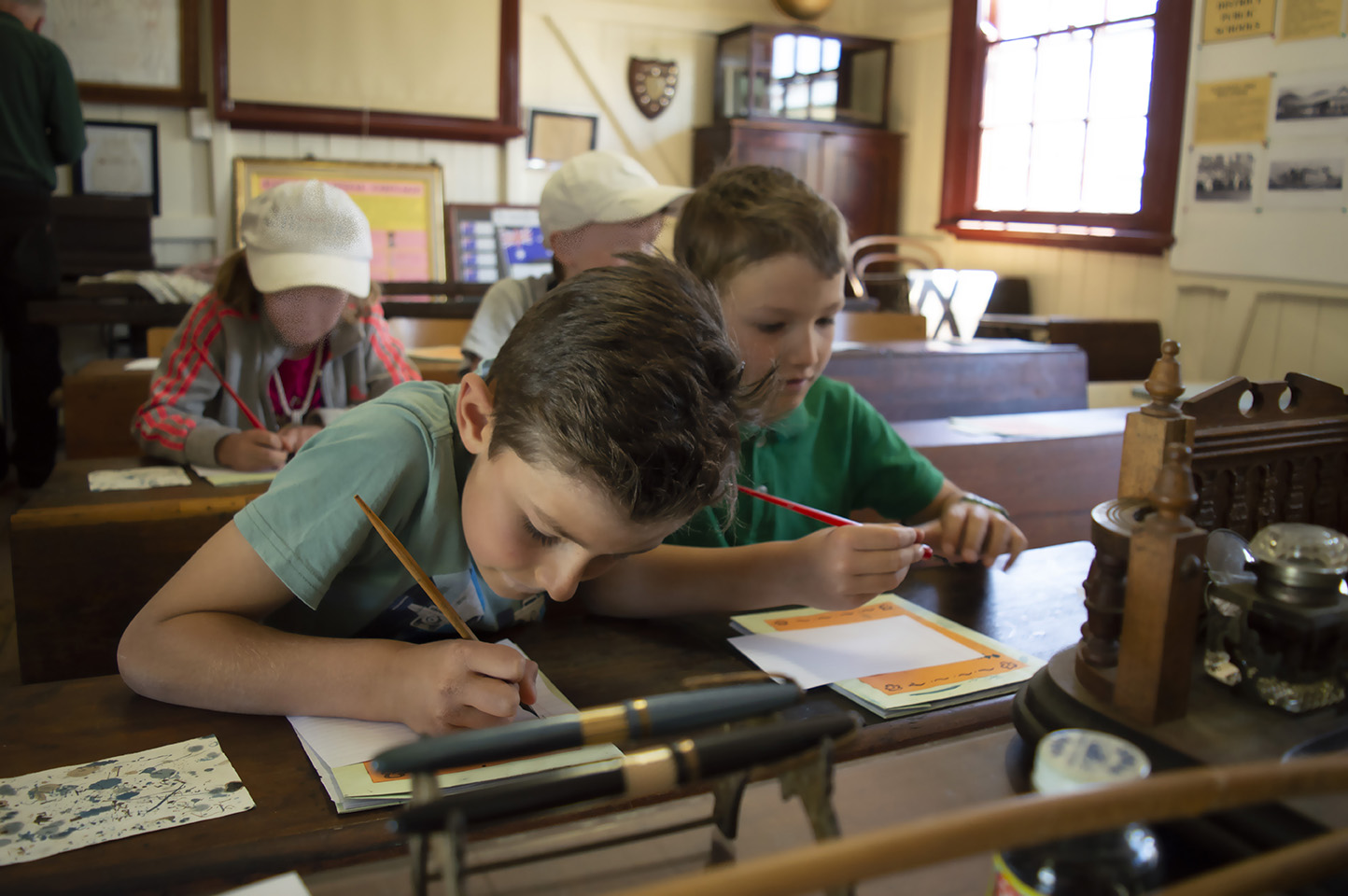 Moonbi Beehive School visiting children writing with pen and ink